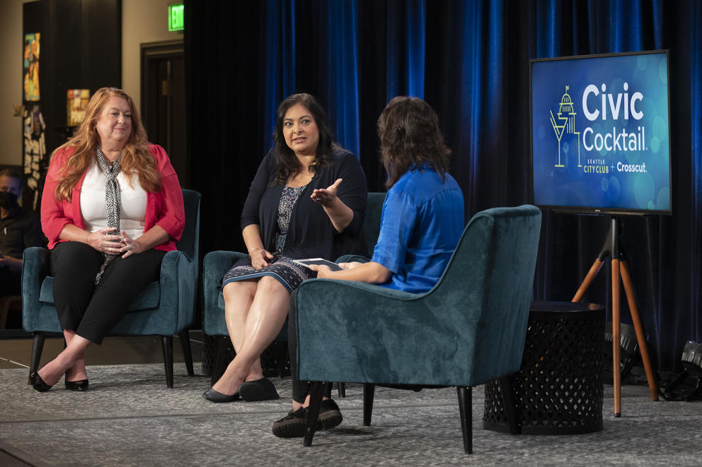 Three women talking onstage