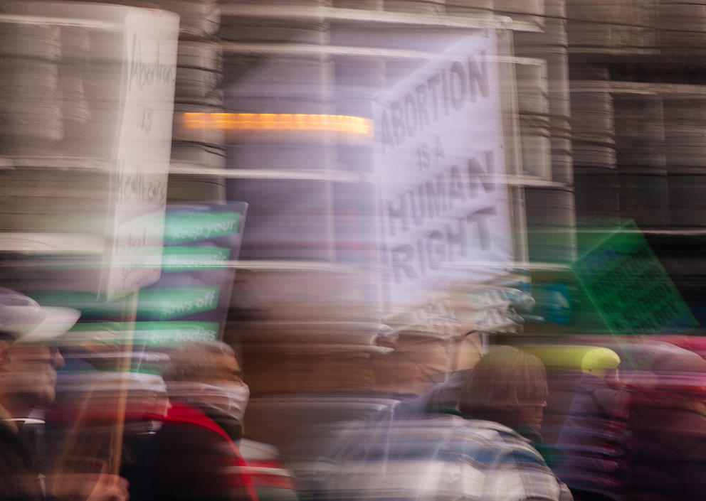 Demonstrator carries a sign reading “Abortion Is a Human Right.”