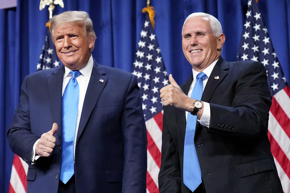 Donald Trump and Mike Pence in front of U.S. flags