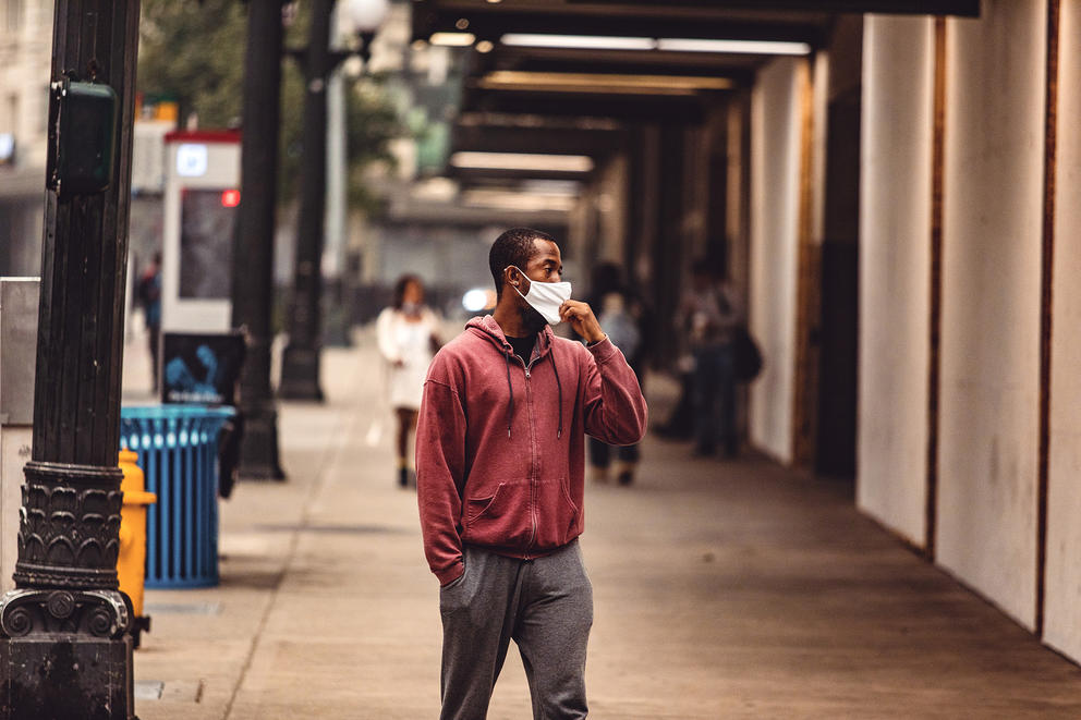 Man in a mask on the sidewalk