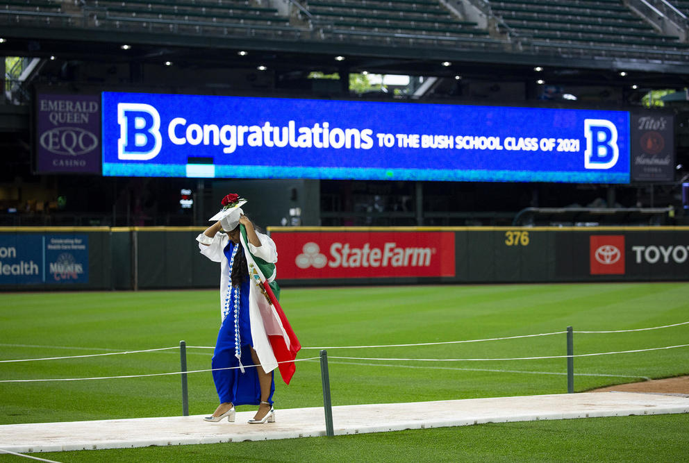 A young woman in a graduation cap and gown