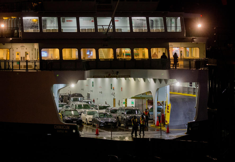 Ferry workers preparing to remove the netting as a ferry arrives in Seattle