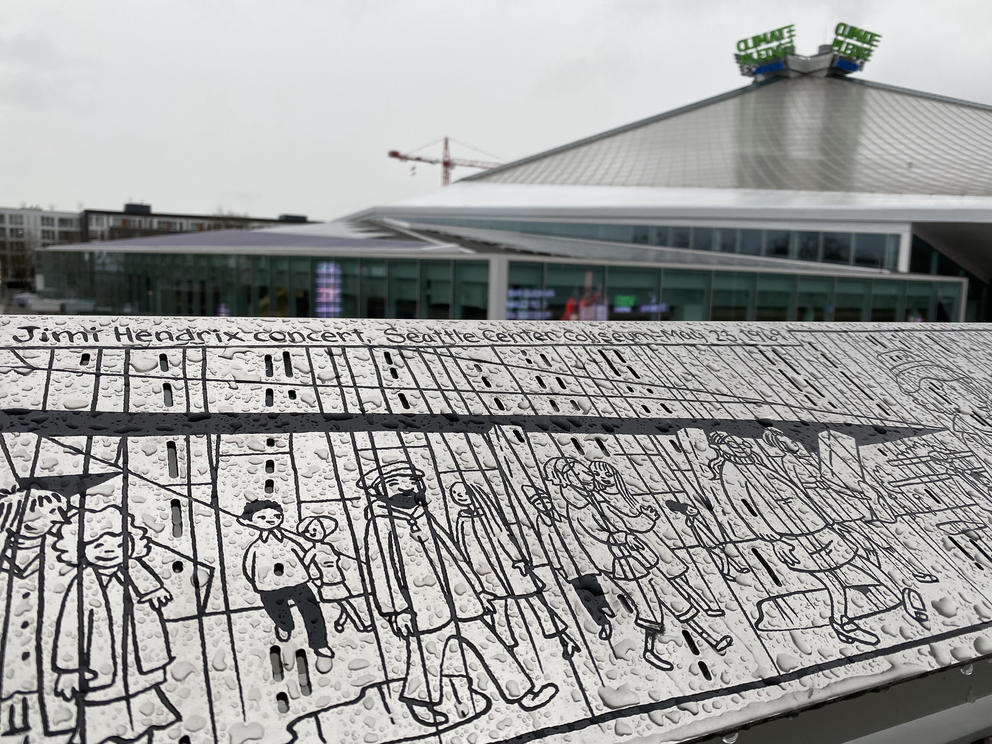 a stainless steel comic panel outside Climate Pledge Arena