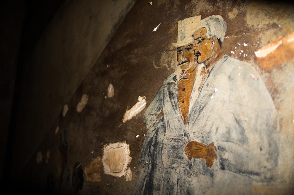 An old mural of two men lines a staircase inside the Louisa Hotel in Seattle's Chinatown International District.