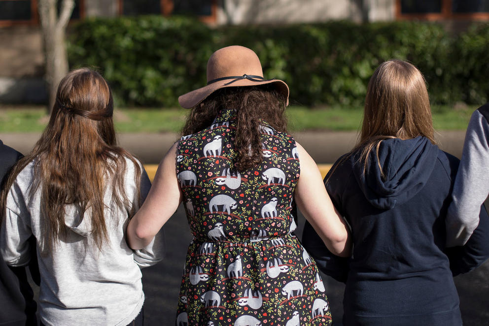 Students link arms for 17 minutes, honoring the 17 killed at a school shooting in Parkland, Florida,