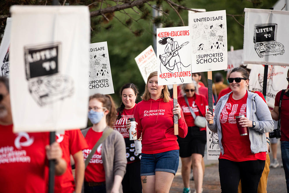 Protestors wearing red picket in a line