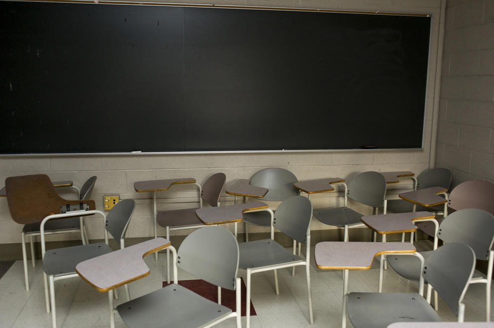 Empty chairs in a classroom.