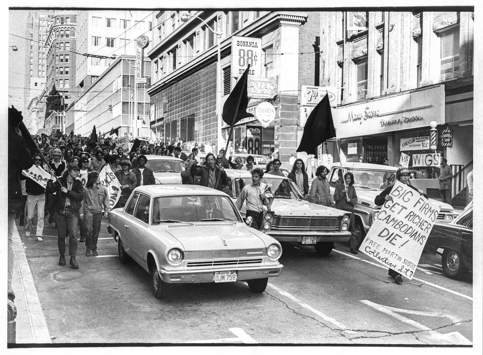 Protestors march among traffic in downtown Seattle