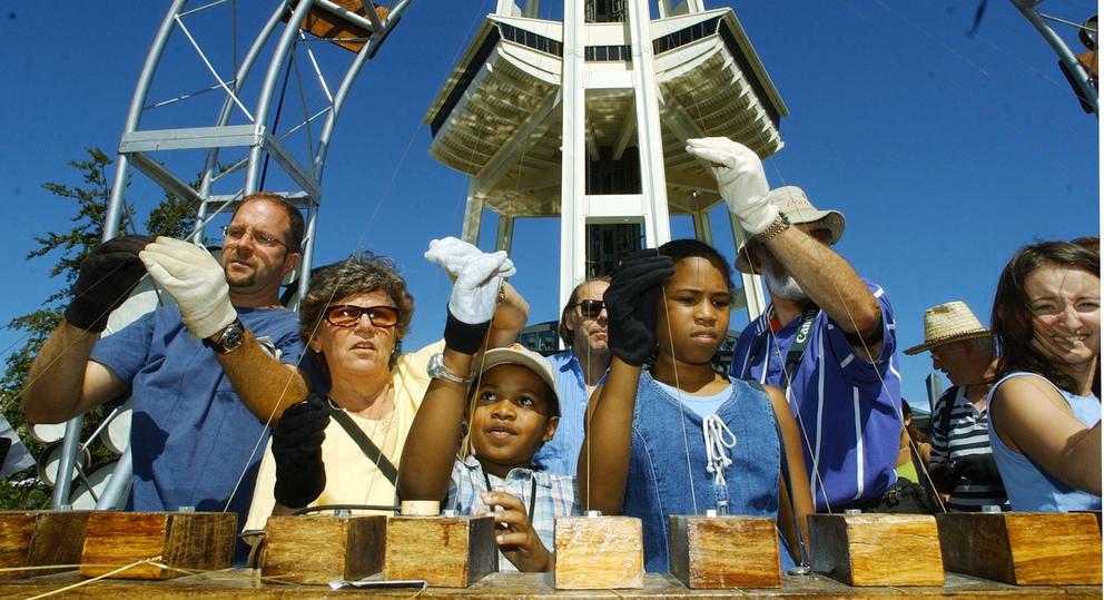 kids playing musical instruments at the base of the Space Needle