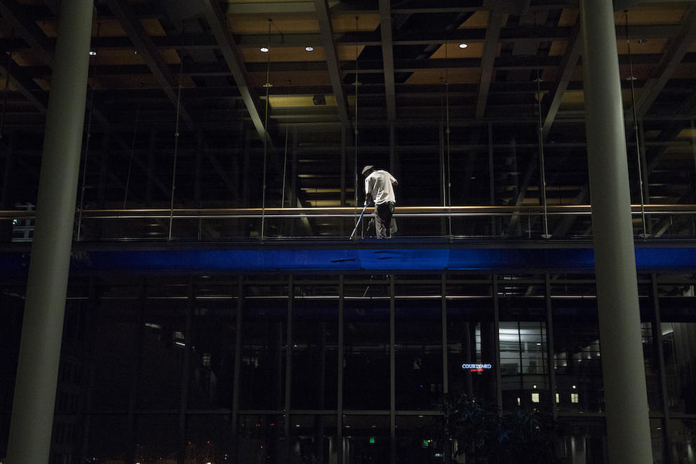 A night janitor is seen cleaning inside 