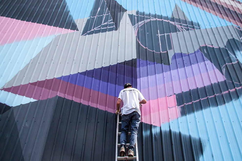 Man working on large art project