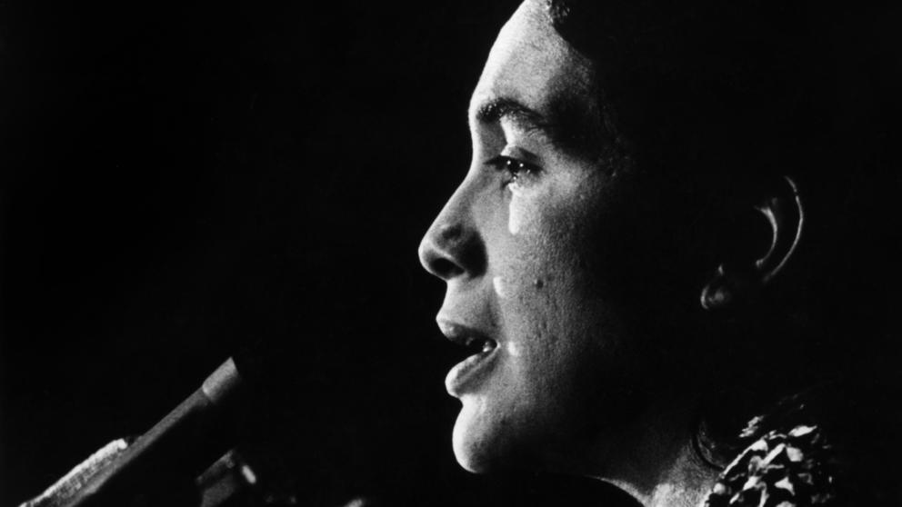 #4 - Dolores Huerta speaks at the podium. c1970s. Courtesy of Walter P. Reuther Library Archives of Labor and Urban Affairs Wayne State University