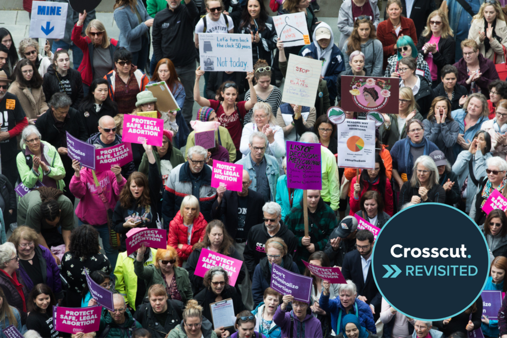 Overhead view of a crow of protesters marching and holding signs