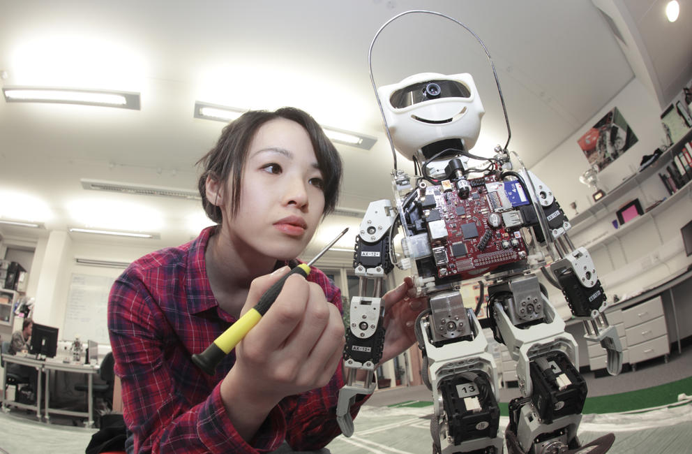 female student building robot