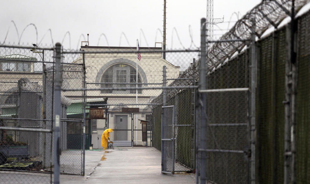 A man working outdoors at a prison