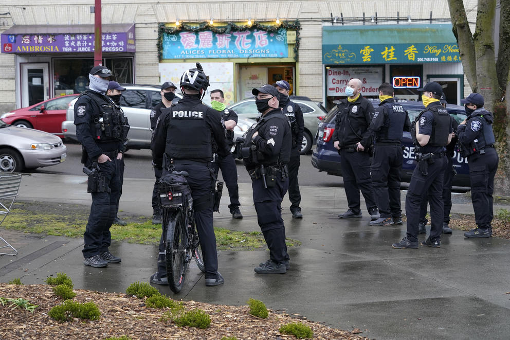 a group of seattle police officers in chinatown-international district