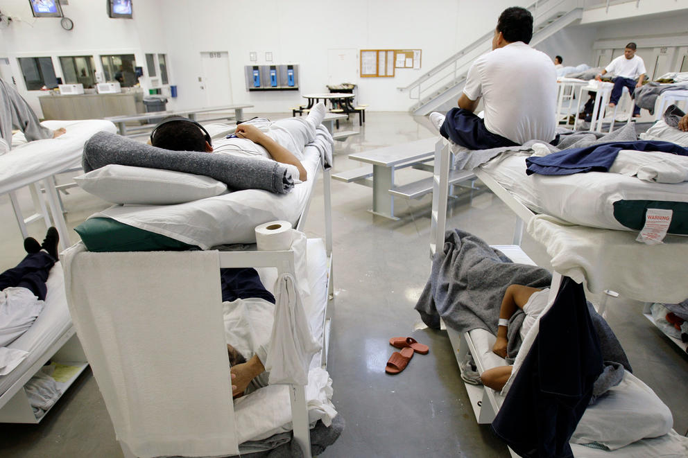 In this photo taken on Friday, Oct. 17, 2008, detainees are shown resting on bunks inside the "B" cell and bunk unit of the Northwest Detention Center in Tacoma, Wash. The facility is operated by The GEO Group Inc. under contract from U.S. Immigrations and Customs Enforcement, and houses people whose immigration status is in question or who are waiting for deportation or deportation hearings. (AP Photo/Ted S. Warren)