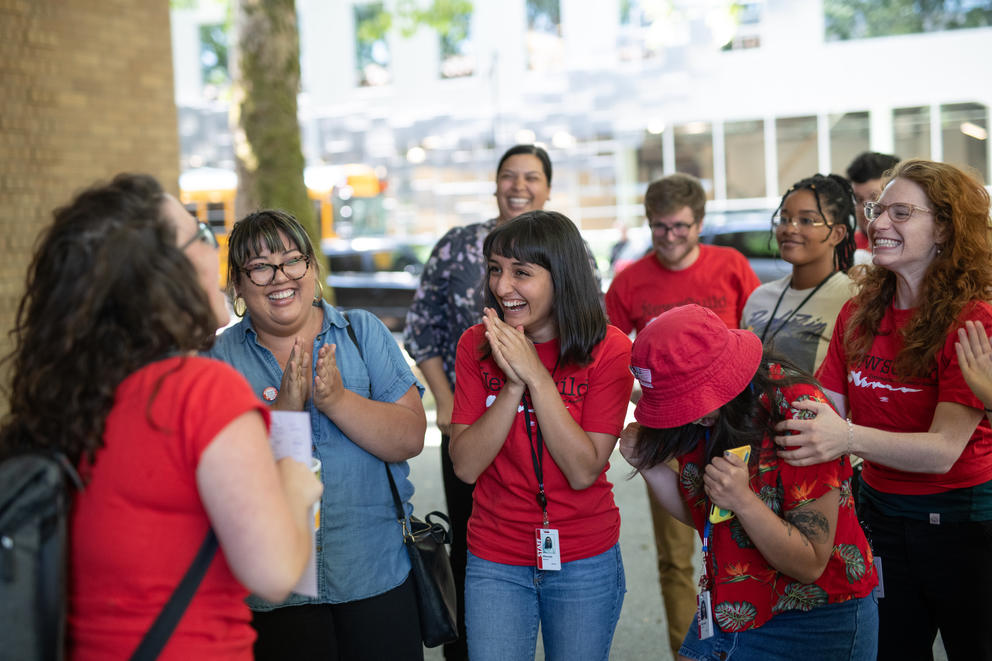 A group of people clapping and cheering