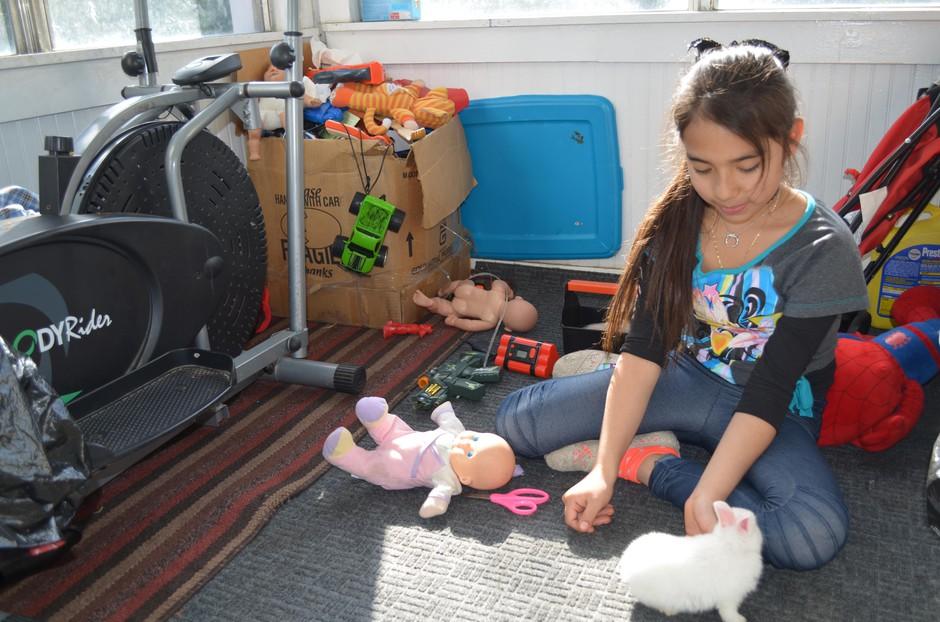 Ten-year-old Azul plays with her pet rabbit at her family's home in Wapato, Washington. 