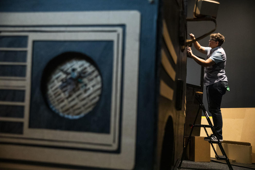 Clyde Petersen works on his tour van installation at Bellevue Arts Museum