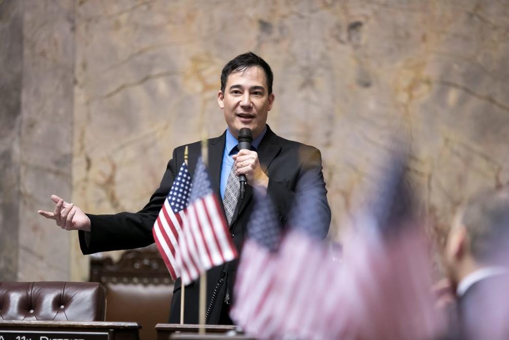 Steve Hobbs speaks into a microphone on the Senate floor