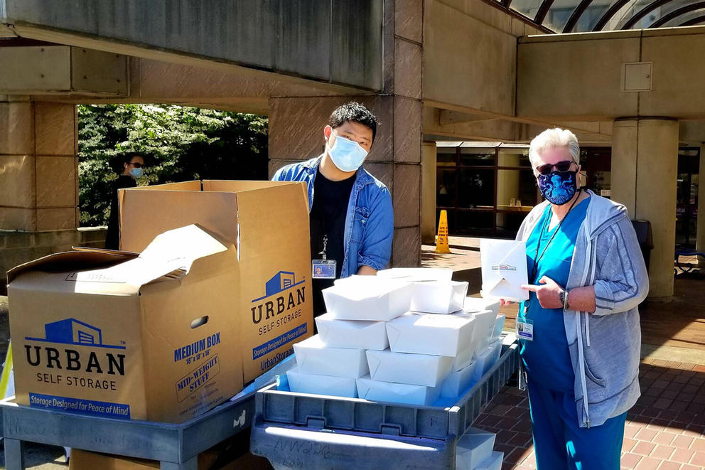 People pose with boxes of donated food