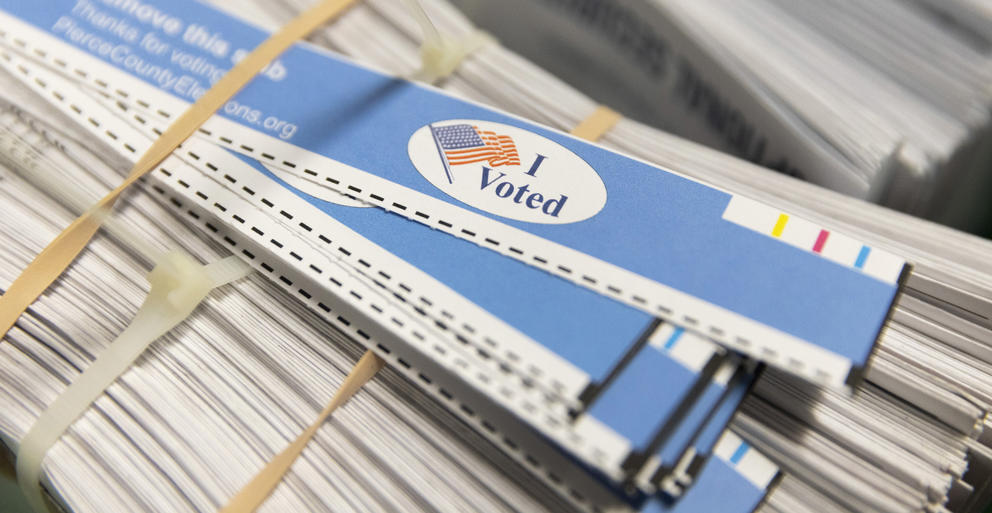 A stack of ballots reads I voted