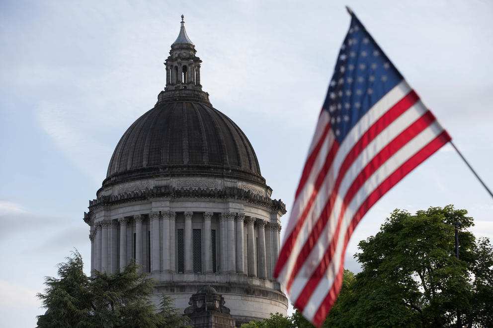 A U.S. flag waves in front of the Capitol dome