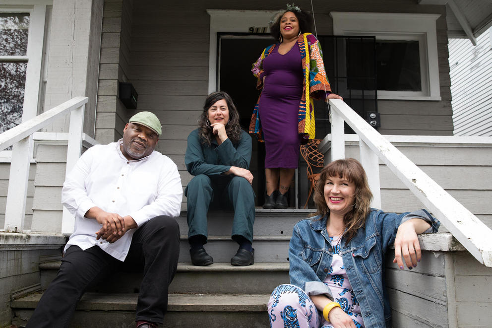 Four people sitting on steps 