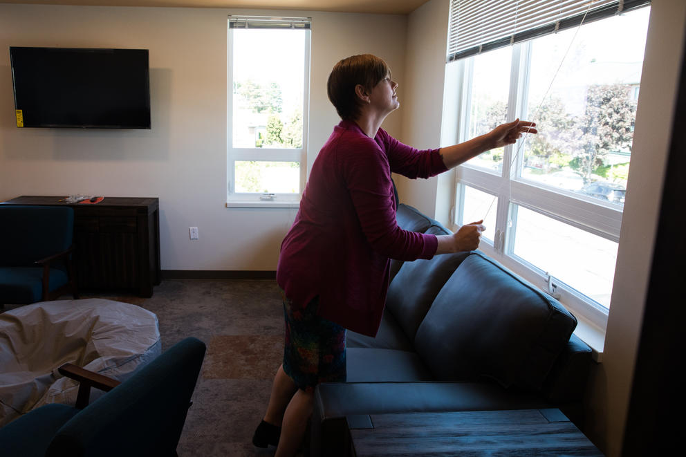 Woman closing blinds