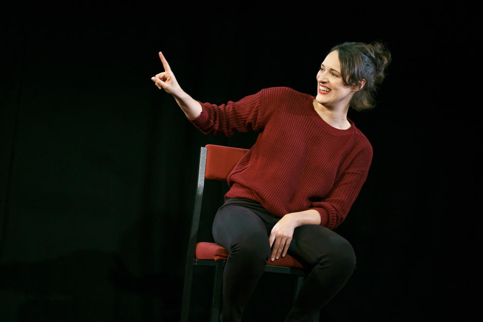 a brunette woman on stage, turned to the side