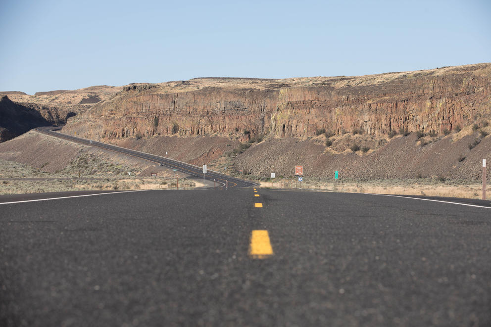 A two-lane highway runs through rocky Central Washington.