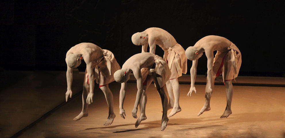 four butoh dancers in white body paint