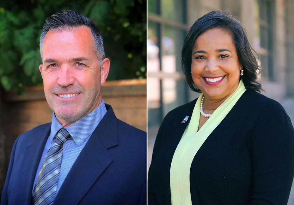 Steve Haverly in blue suit and tie at left, Victoria Woodards in black suit jacket over yellowish green blouse at right