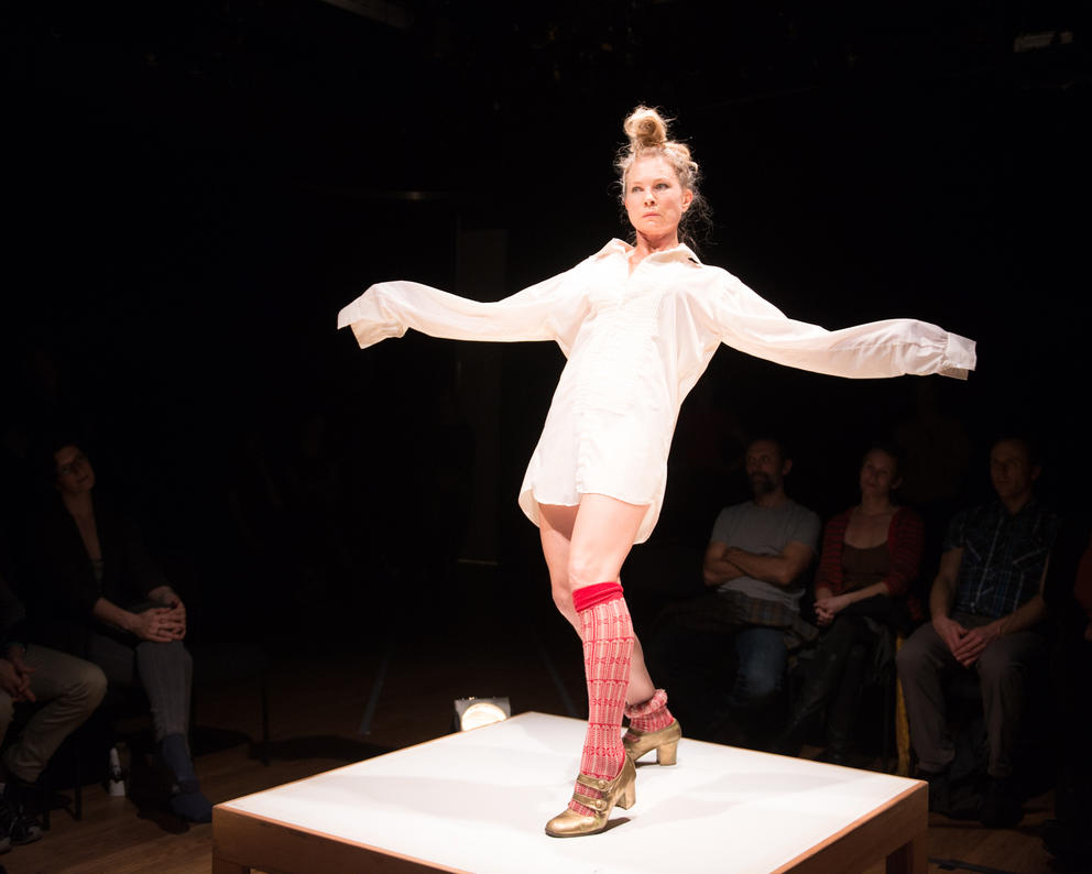 a woman dances in kneesocks on a small stage