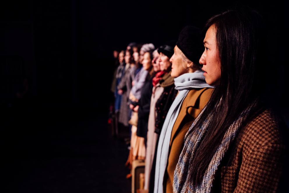 a group of actors standing in a long line