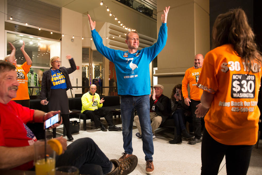 Tim Eyman and supporters react to early positive returns for I-976.