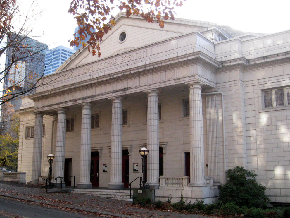 photo of a neoclassical white building with five columns across the portico