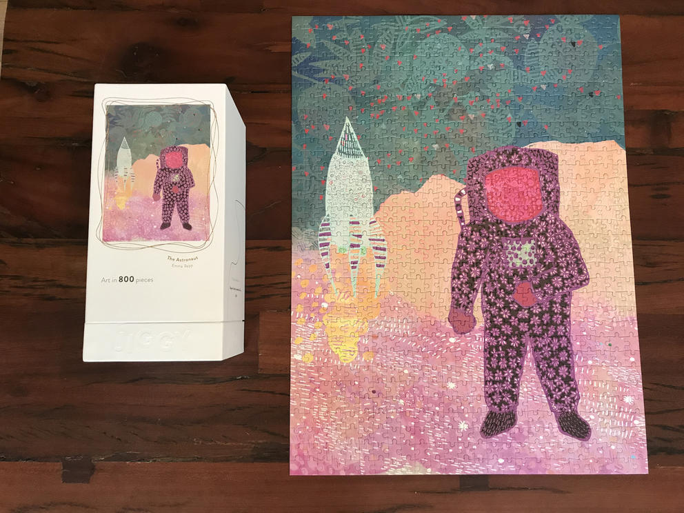 a puzzle depicting an astronaut in a purple suit