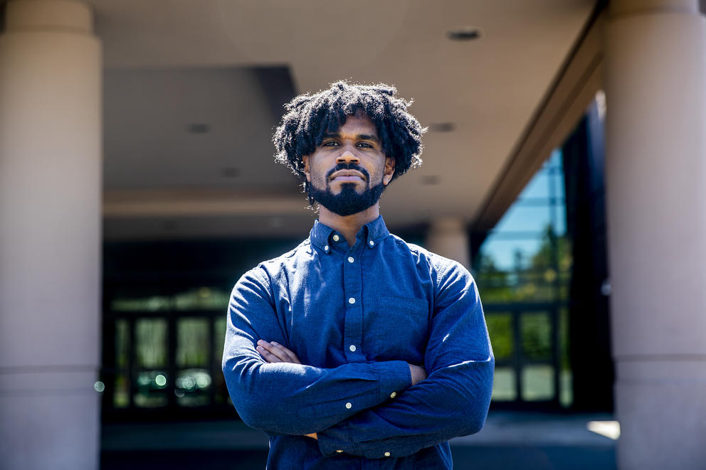 State Rep. Jesse Johnson stands with his arms folded across his chest