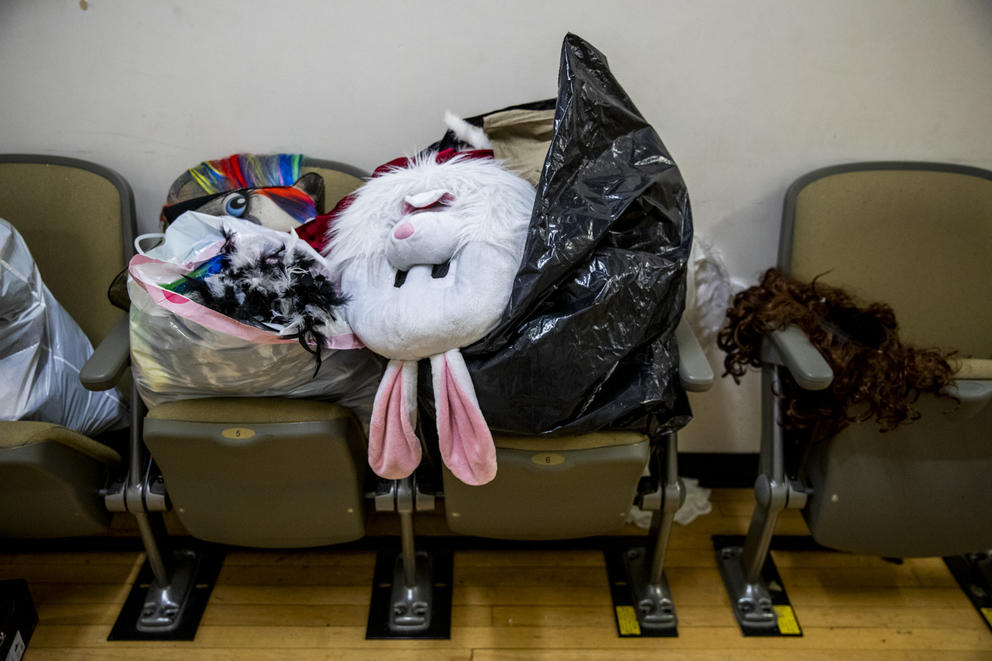 Costumes in trash bags backstage