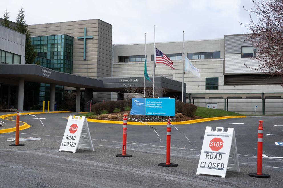 Road closure signs in front of a hospital driveway