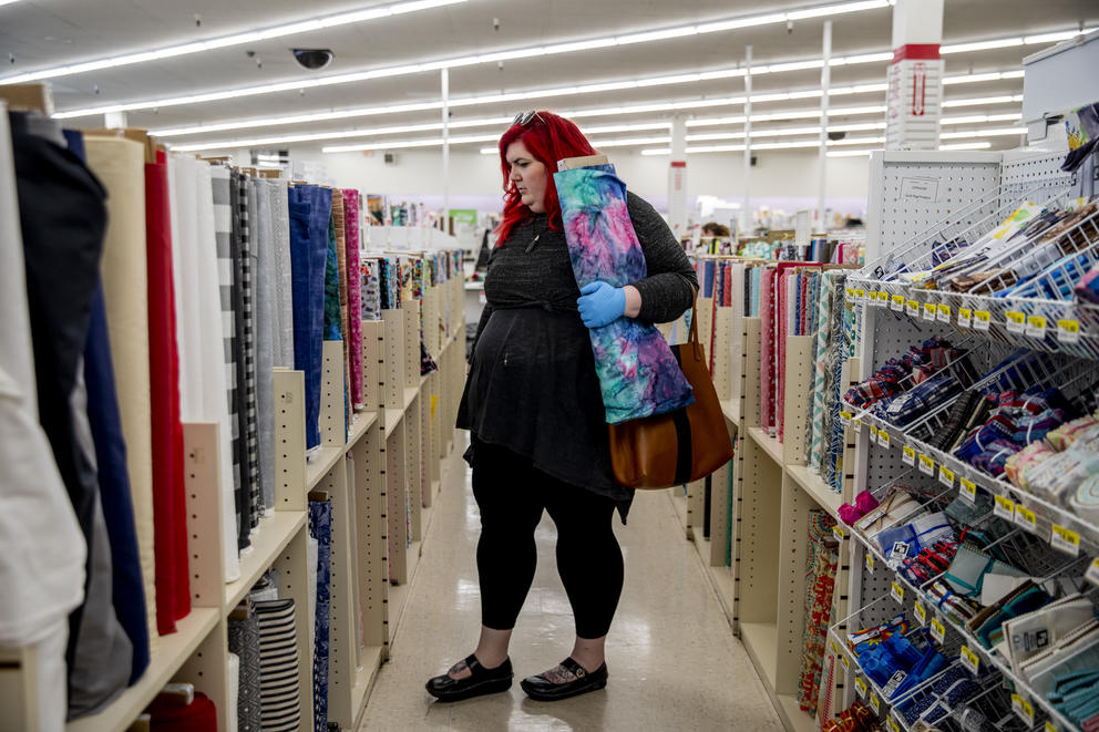 A customer looks for fabric in store to make masks