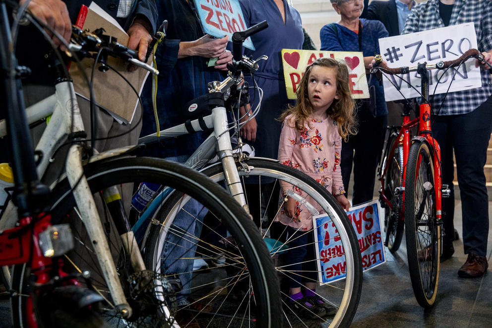 Ava Rigel looks up at bike protestors