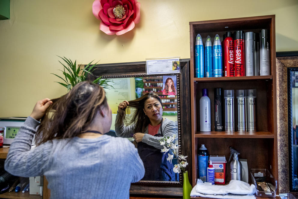 Nary fixes her hair in the mirror