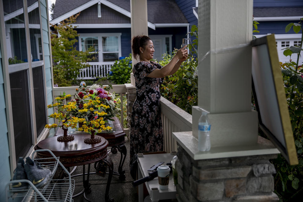 Nary takes a photo from the front porch