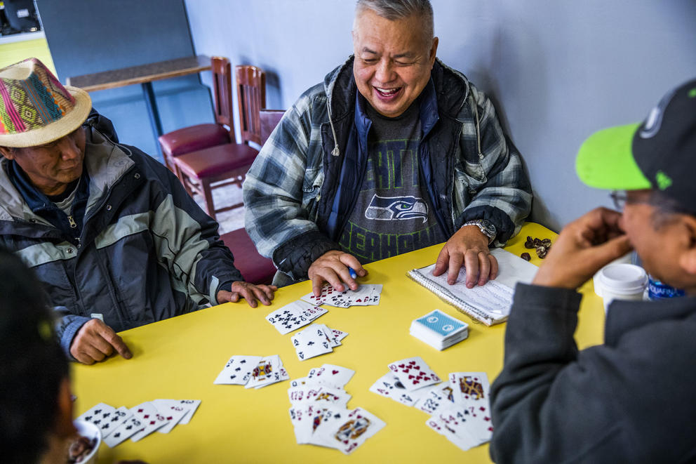 Ed Campos, 68, of Seattle plays a game of cards with other regulars at King Donuts in Rainier Beach on Wednesday, Nov. 14, 2018. Campos says he has been coming to King Donuts for the last 30 years.