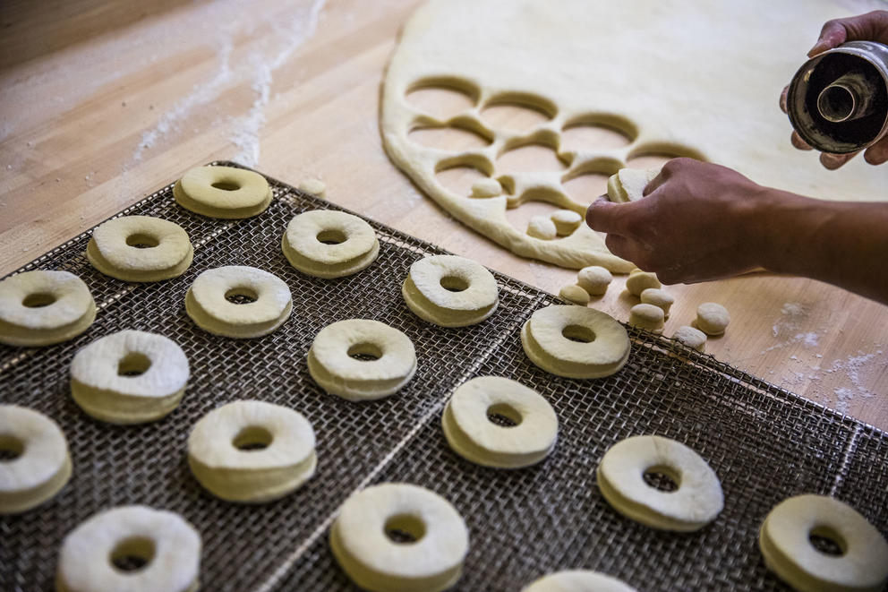 Travis Chhuor, 30, prepares doughnuts in the morning at King Donuts in Rainier Beach on Sunday, Nov. 18, 2018. Chhuor says he has been baking for his family's doughnut shops since his mother told him he'd be baking for her starting the morning after his high school graduation.