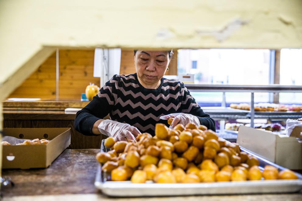 Owner Kim Sok fills a box with doughnuts at King Donuts in Rainier Beach on Sunday, Nov. 18, 2018.