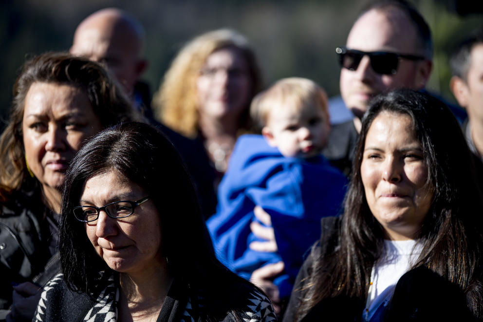 People listen to a press conference